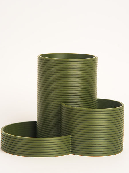 Set of green ribbed planters on a white background
