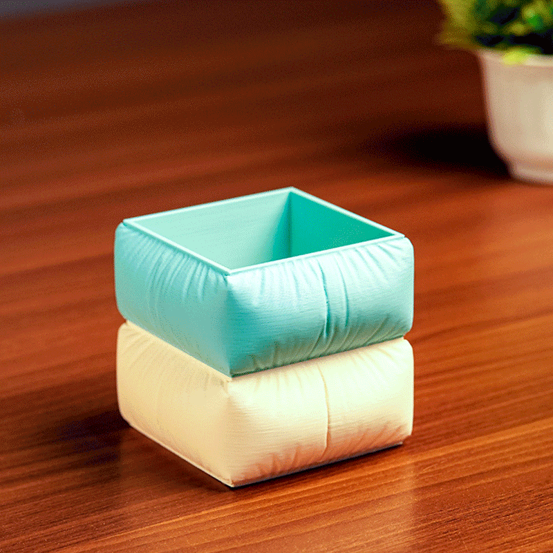 Set of colorful square-shaped pencil holders with pens on a light background in Sofa shape
