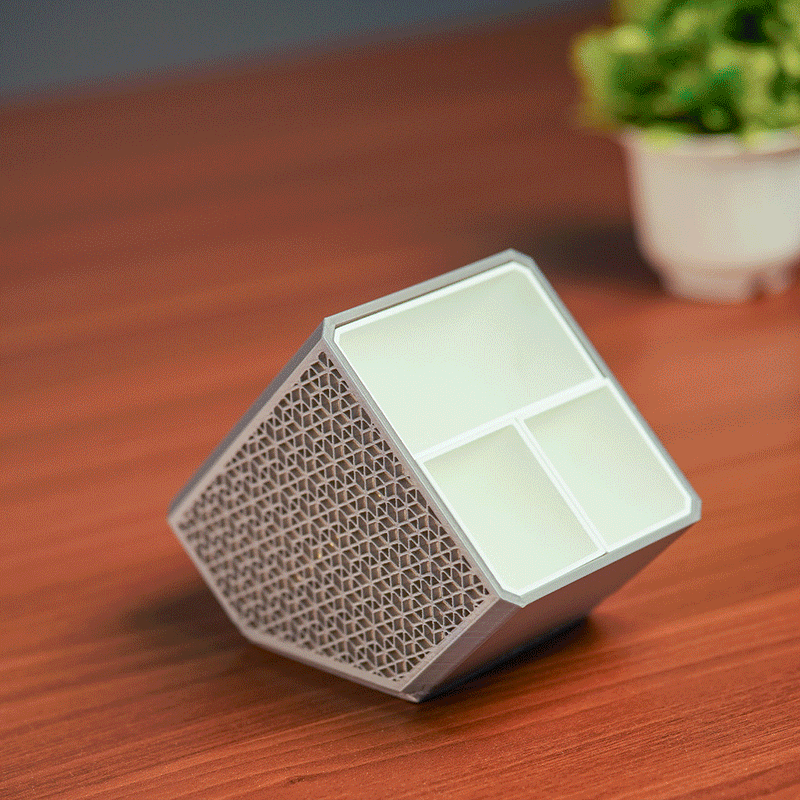 Stylish angled desk organizer with four compartments, holding colorful pens and markers, ideal for office or home workspace organization.